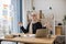 Businesswoman meditating in office chair behind computer