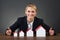 Businesswoman With Model Houses Arranged In Graph Order