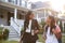 Businesswoman Mother Walking Daughter To School On Way To Work