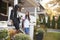 Businesswoman Mother Walking Daughter To School On Way To Work