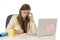 Businesswoman in at office computer desk talking on mobile phone taking notes