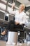 Businesswoman in office throwing garbage in bin