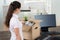 Businesswoman Packing Belongings In Cardboard Box