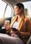 Businesswoman, phone and coffee in car for travel to work with smile in happiness, alone and profile. Young, person and