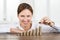 Businesswoman Placing Coin To Stack Of Coins