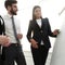 Businesswoman pointing marker to flipboard on presentation in office