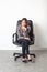 Businesswoman posing sitting in office chair for first job