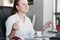 Businesswoman practices breathing exercises at workplace, woman