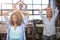 Businesswoman practicing yoga with colleagues