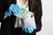 Businesswoman in a protective mask and protective gloves puts a bundle of paper banknotes into the envelope