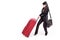 Businesswoman pulling heavy suitcase