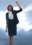 Businesswoman raising fist with intense clouds