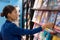 Businesswoman reading magazines at newsstand store of airport or train station. Asian woman shopping at bookstore