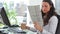 Businesswoman reading a newspaper while drinking coffee