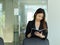 Businesswoman reading schedule book while standing in office room