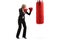 Businesswoman with red boxing gloves exercising with a punching bag