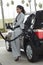 Businesswoman Refueling Car At Station