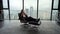 Businesswoman relaxing on chair in office. Woman smelling aroma of wine in glass