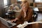 Businesswoman Remote Homework Concept. Female With Laptop. Mature Woman In Brown Jacket Drinks From Cup.