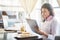 Businesswoman in a restaurant reading contract document.