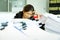 Businesswoman resting hands on head with eyes close at work desk in office.