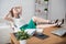 Businesswoman resting relaxing legs on the table hands behind her head and sitting a chair in office.