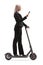 Businesswoman riding an electric scooter and using a mobile phone