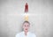 Businesswoman with rocket over head
