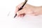 Businesswoman`s hand with pen completing personal information on a form