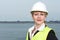 Businesswoman in safety vest and hardhat standing outdoors