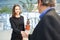 Businesswoman says goodbye to a colleague with a handshake