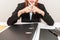 Businesswoman says no with cross fingers on at her office