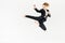 businesswoman screaming jumping and performing kick in suit