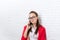 Businesswoman serious cell phone call wear red jacket glasses talking on mobile