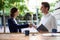 Businesswoman shaking hands with businessman at counter