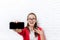 Businesswoman show cell smart phone screen with empty copy space wear red jacket glasses happy smile