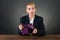 Businesswoman Showing Empty Clutch At Desk