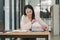 A businesswoman is sifting through stacks of paper files and folders that contain both incomplete and completed