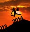 Businesswoman silhouette jumps over 2014 New Year