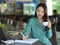 Businesswoman sipping coffee while working on financial report at office