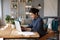 Businesswoman sit at desk in modern room texting on laptop