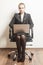 Businesswoman sits on chair with her laptop