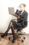 Businesswoman sits on chair and work