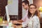 Businesswoman sitting with coworker while working on computer