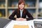 Businesswoman sitting at desk with employment agreement document