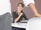 Businesswoman Sitting At Desk Looking At Male Colleague