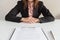 Businesswoman sitting with employment agreement in front of her