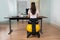 Businesswoman Sitting On Fitness Ball In Office