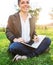 Businesswoman sitting on the grass