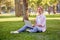 Businesswoman sitting grass summer park using laptop